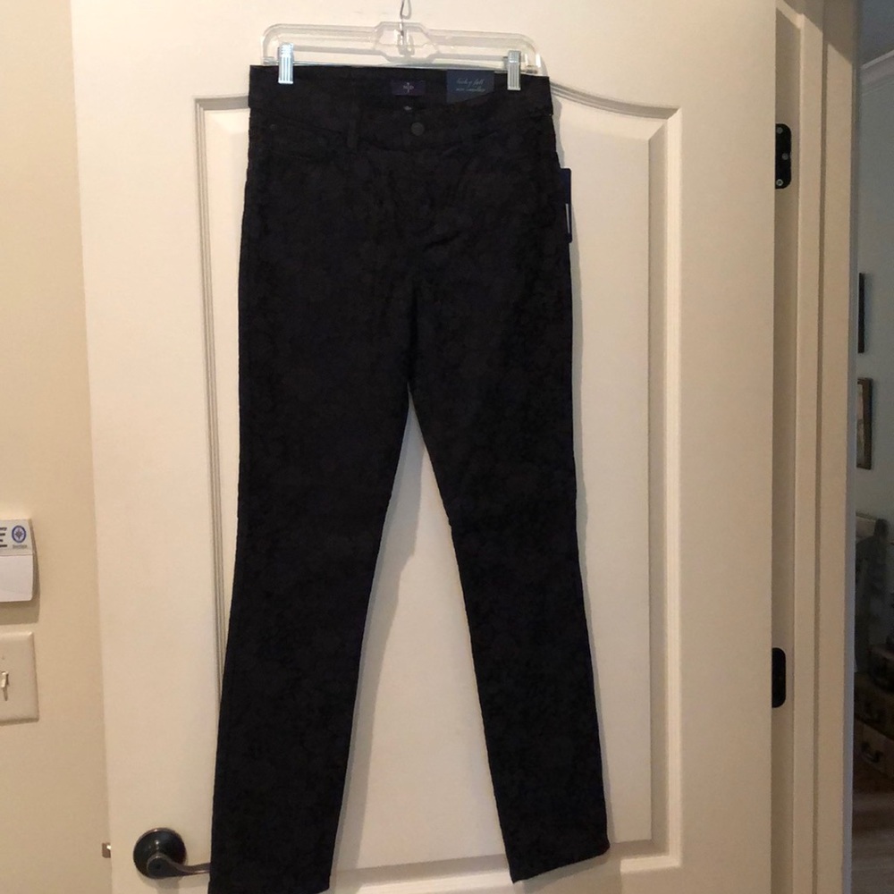 Black jean-style pants with tapestry like fabric.